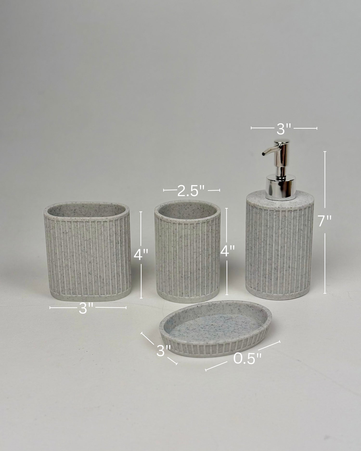 High Objects Calmridge Bathroom Accessory Set: speckled grey resin soap dispenser, toothbrush holder, tumbler, and soap dish with ribbed texture.