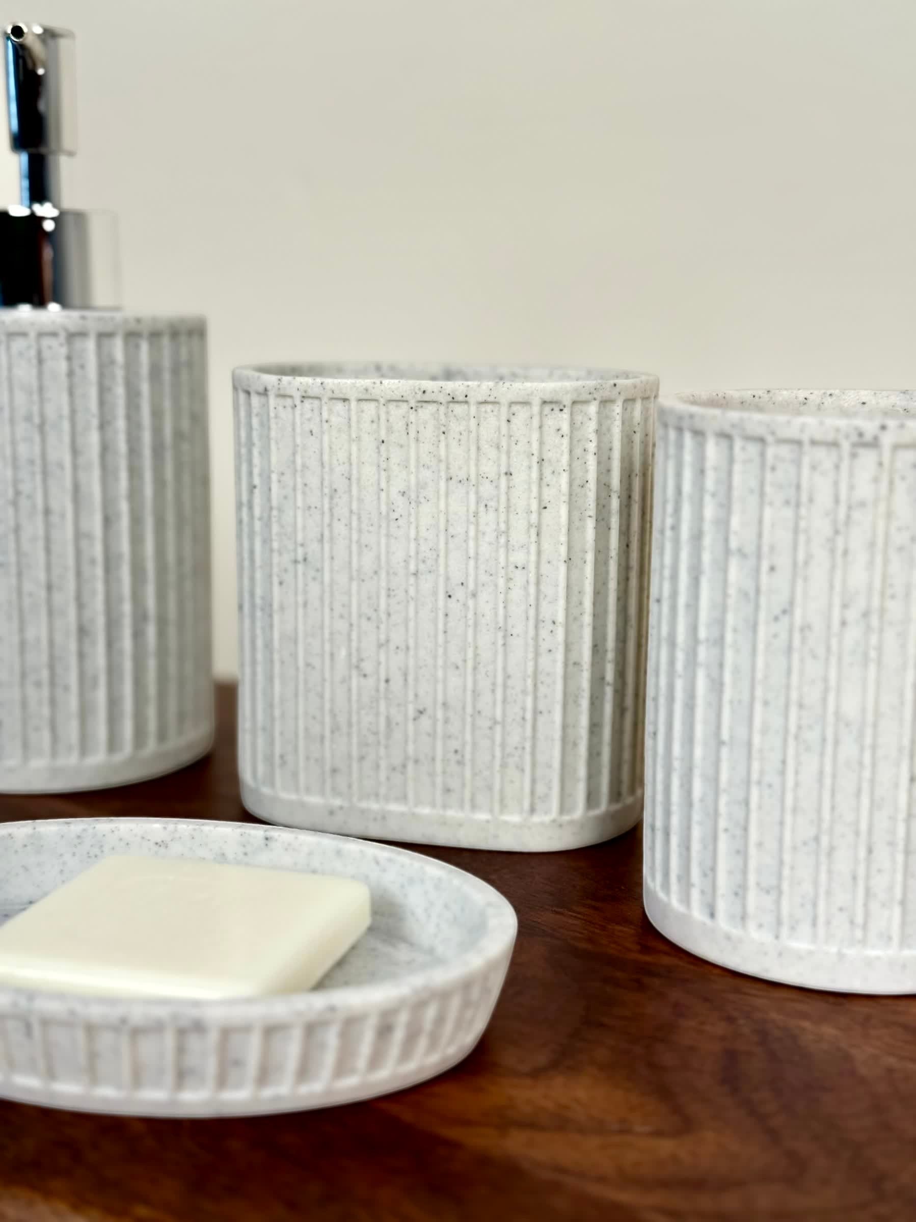 High Objects Calmridge Bathroom Accessory Set: Speckled white ceramic soap dish with soap, dispenser, and tumbler with ribbed texture.