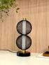 High Objects Celeste Duo Mesh Table Lamp with stacked black mesh spheres and brushed gold accents on a black base.