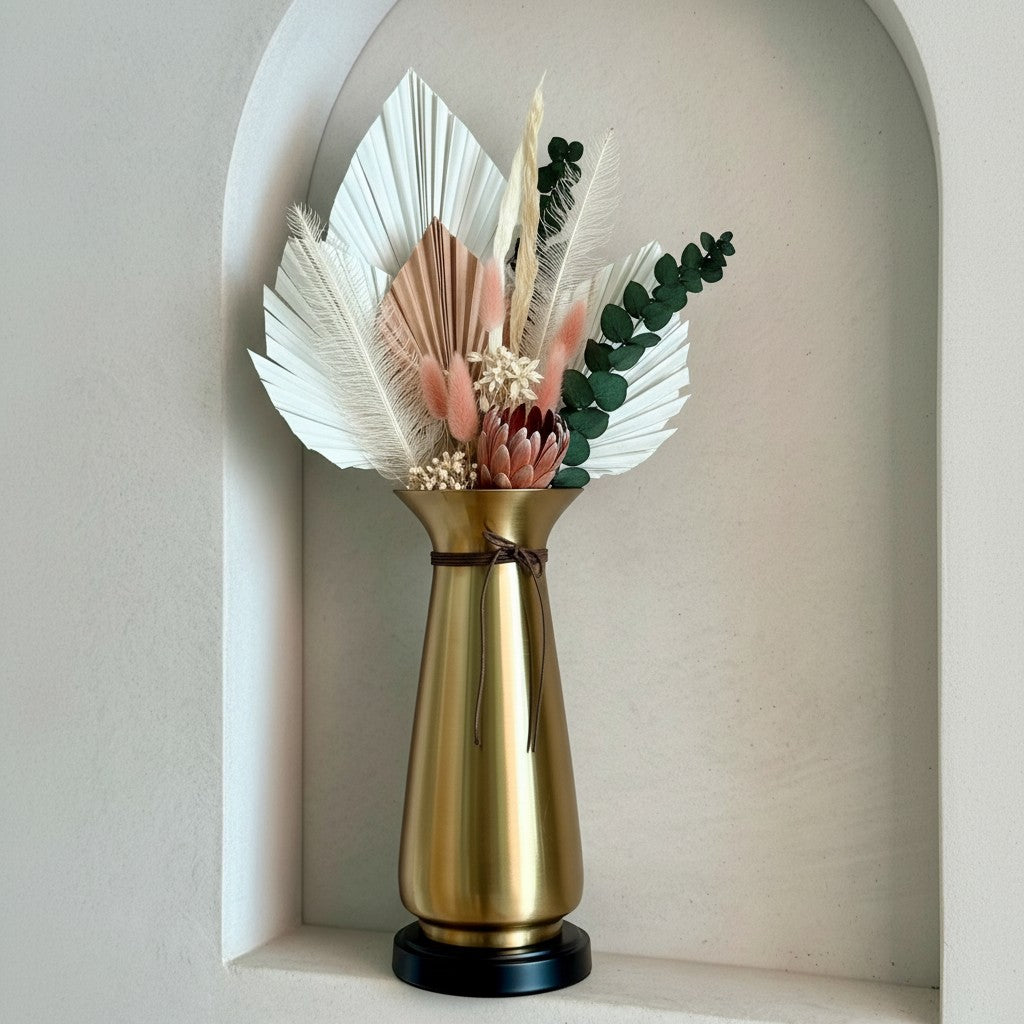 High Objects Celestia Vase: gold tapered vase with flared rim, cord detail, and black base, holding dried floral arrangement.
