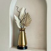 High Objects Celestia Vase: Tapered gold vase with flared rim, cord detail, and black base. Features dried palm leaves and pampas grass.