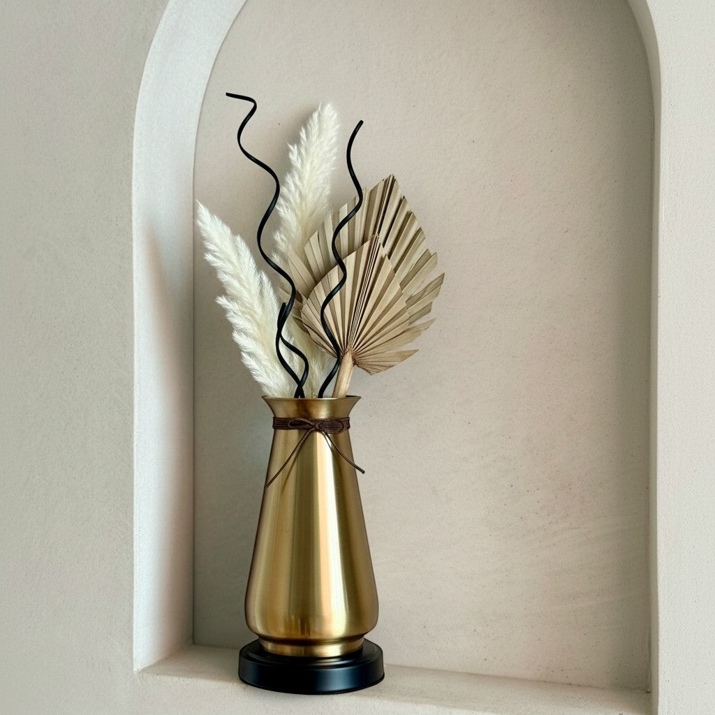 High Objects Celestia Vase: Tapered gold vase with flared rim, cord detail, and black base. Features dried palm leaves and pampas grass.