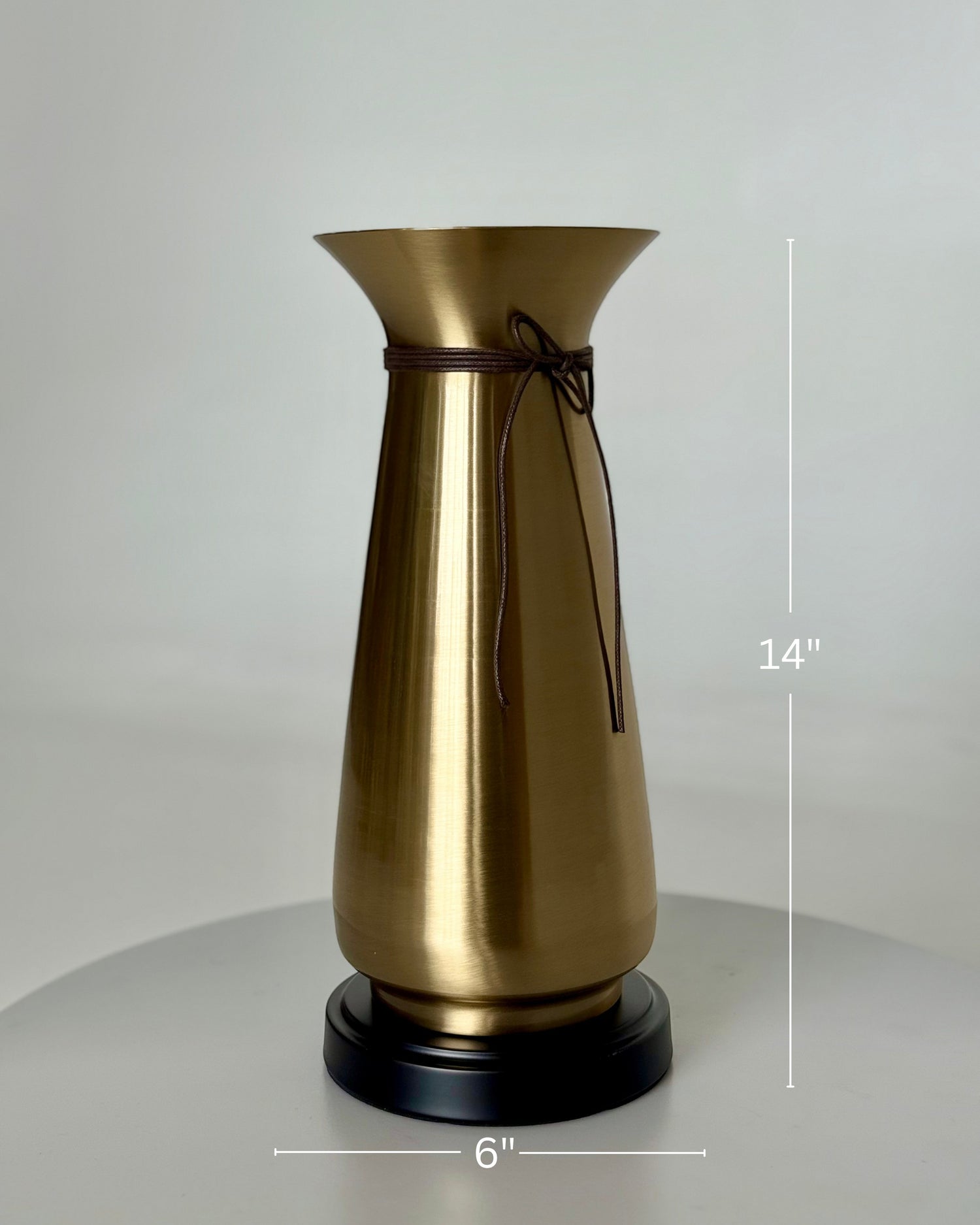 High Objects Celestia Vase, a 14-inch tall gold tapered vase with a flared rim, cord detail, and black base.