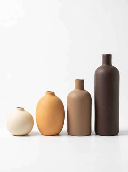 High Objects set of 4 matte ceramic vases in brown, beige, dark brown, and ochre.