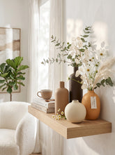 High Objects set of 4 matte ceramic vases in brown, beige, dark brown, and ochre.