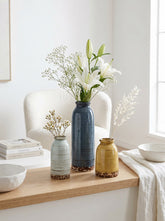 High Objects set of 3 ceramic vases in blue, yellow, and light blue with textured horizontal lines and brown speckled bases.