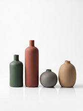 High Objects set of 4 matte ceramic vases in green, rust, grey, and tan. Various shapes and sizes.