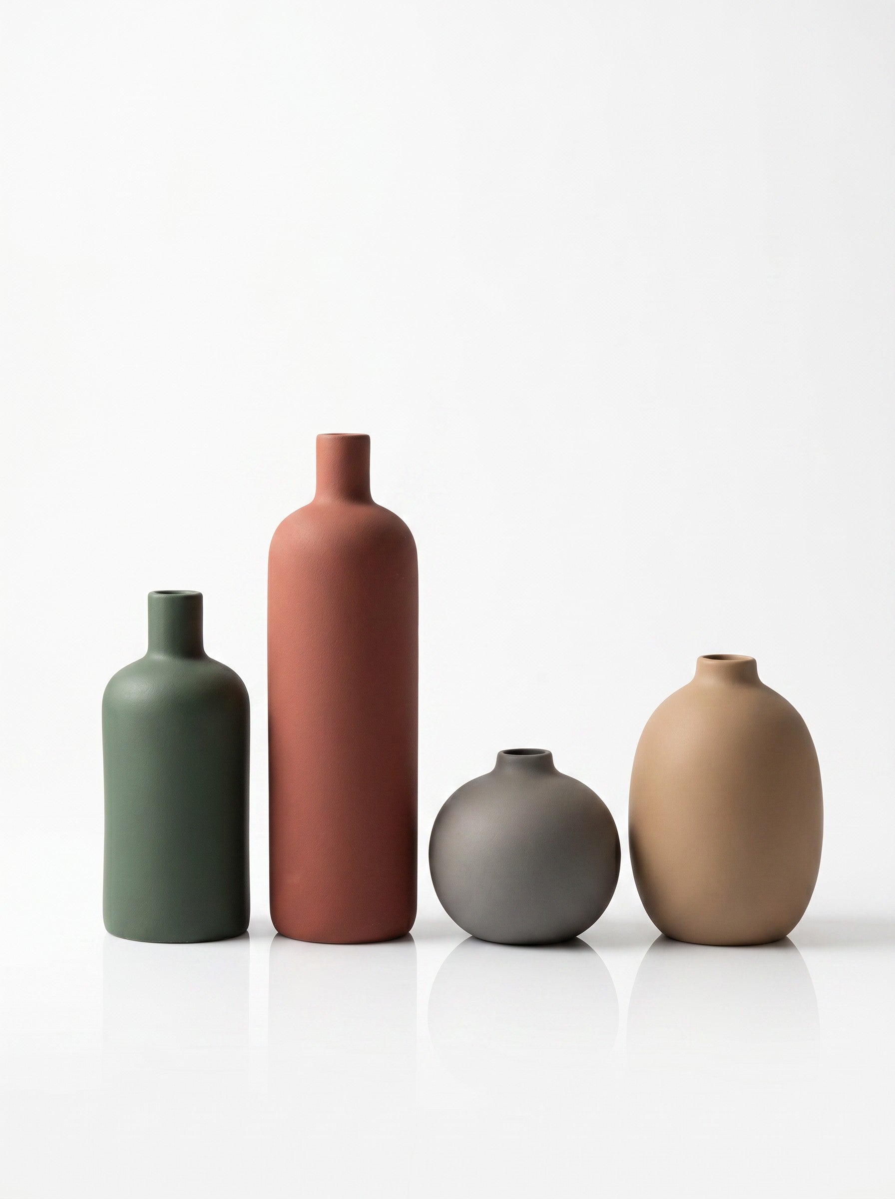 High Objects set of 4 matte ceramic vases in green, rust, grey, and tan. Various shapes and sizes.