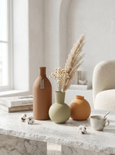 Set of three matte ceramic vases in terracotta, light green, and orange by High Objects.