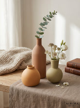 High Objects set of 3 ceramic vases in terracotta, sage green, and orange. Round and bottle shapes.