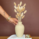 High Objects ClayHaven Vase, a textured matte beige ceramic vase holding dried bunny tail grass in green and tan.
