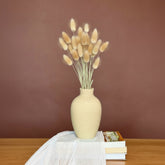 High Objects ClayHaven Vase, a textured beige ceramic vase with dried bunny tail grass and eucalyptus stems.