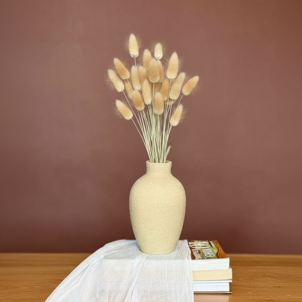 High Objects ClayHaven Vase, a textured beige ceramic vase with dried bunny tail grass and eucalyptus stems.