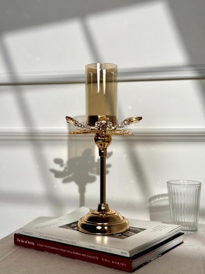 High Objects Crystal Bloom candle stand with amber glass hurricane and crystal petal accents on a gold pedestal base.