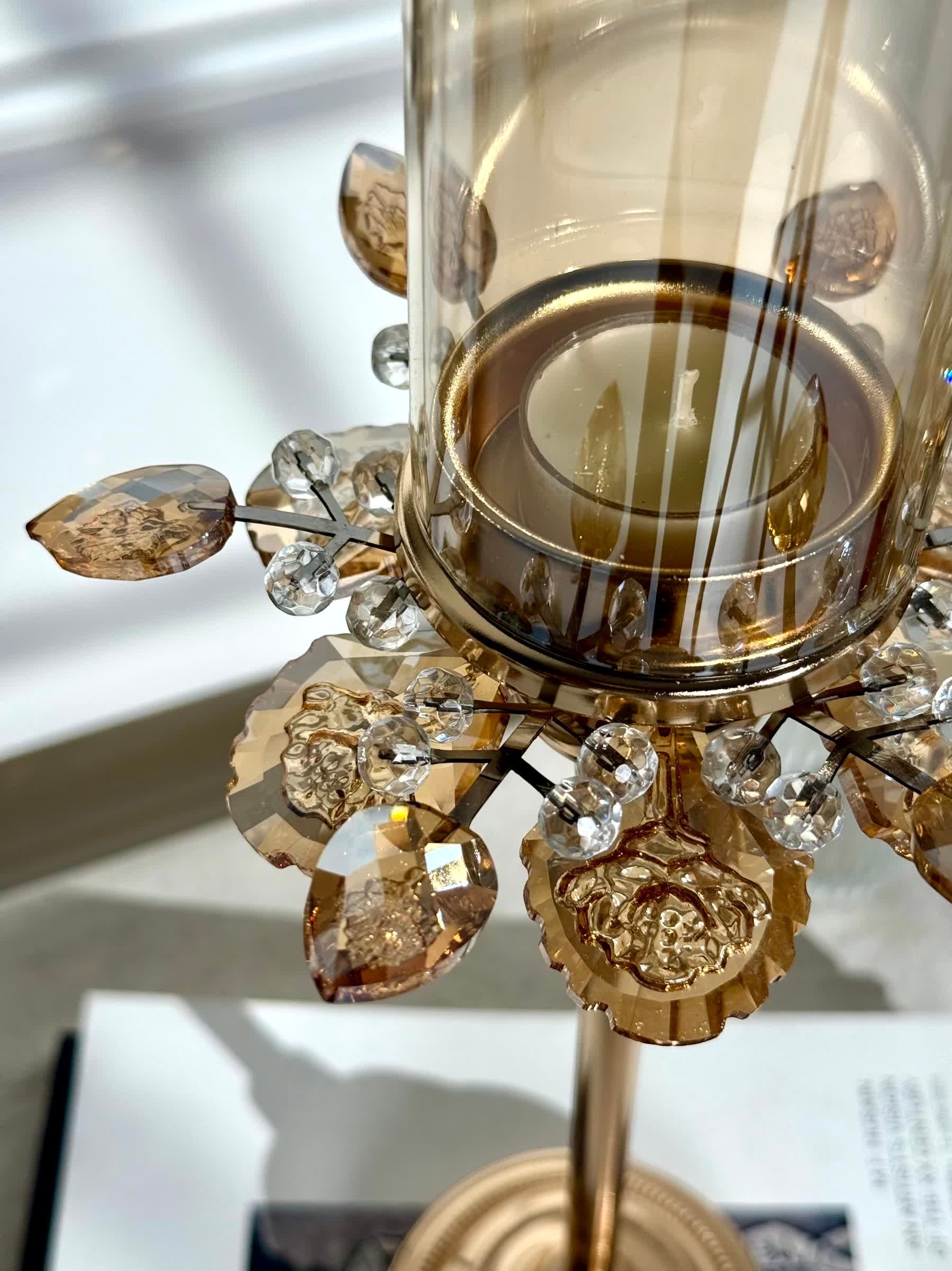 High Objects Crystal Bloom candle stand with amber glass hurricane and crystal petal accents.