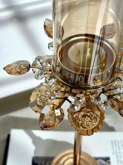 High Objects Crystal Bloom candle stand with amber glass hurricane and crystal petal accents.