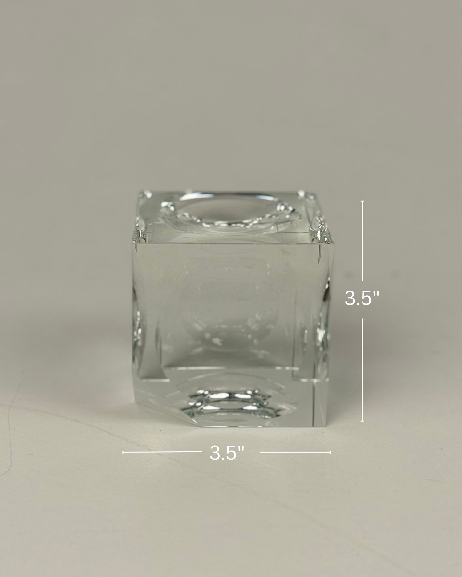 High Objects clear crystal cube artefact with sharp edges, reflecting light. Modern sculptural décor.
