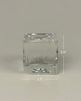 High Objects clear crystal cube artefact with sharp edges, reflecting light. Modern sculptural décor.