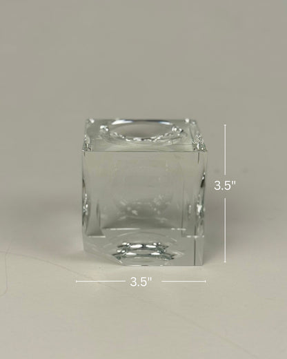 High Objects clear crystal cube artefact with sharp edges, reflecting light. Modern sculptural décor.