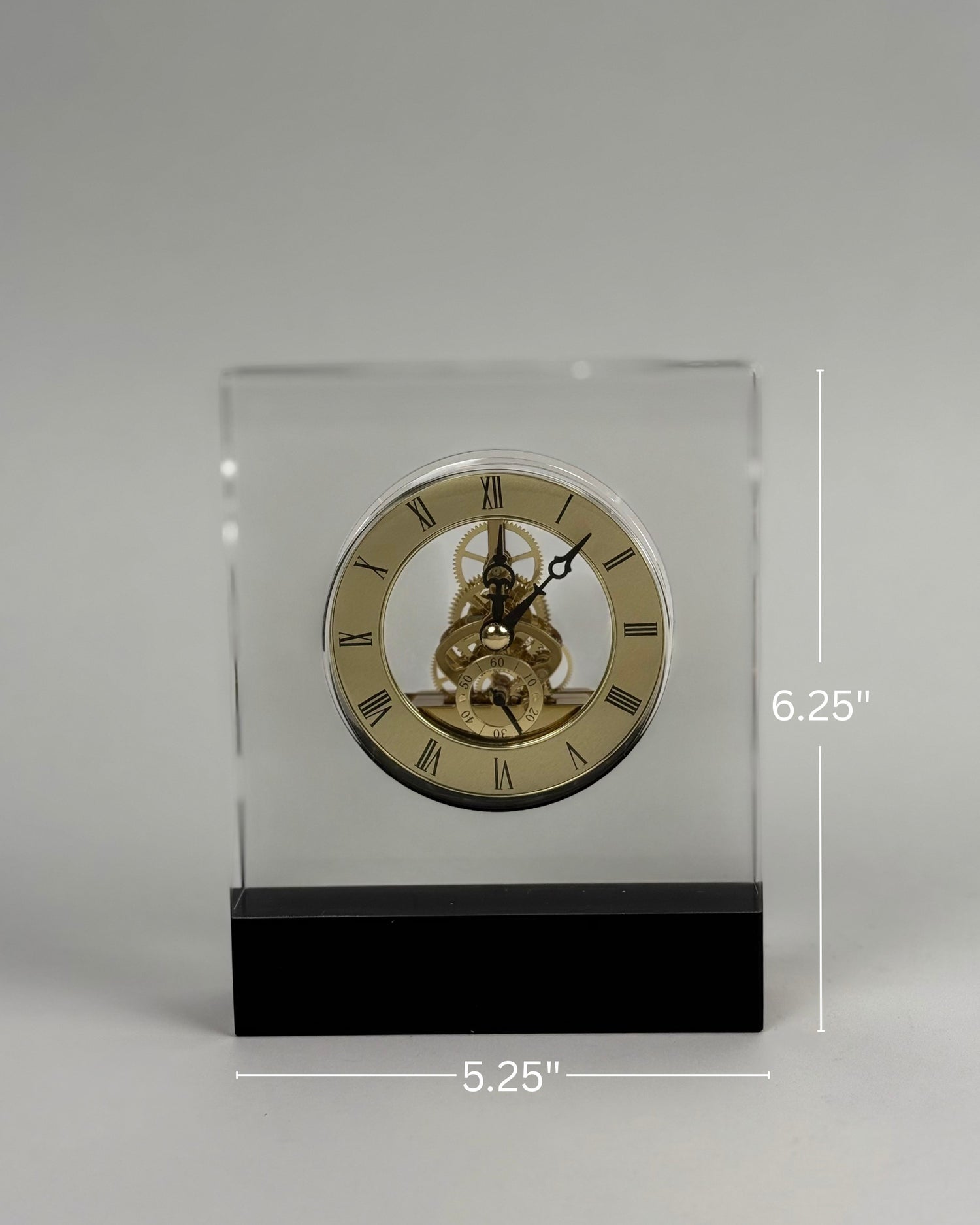 High Objects Crystal Block Gear Desk Clock with gold-tone Roman numerals and exposed gears on a black base.