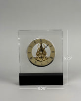 High Objects Crystal Block Gear Desk Clock with gold-tone Roman numerals and exposed gears on a black base.