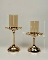 High Objects set of two gold candle stands with amber glass shades and crystal-style droplet accents. 12" and 10" tall.