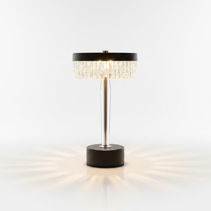High Objects Crystal Halo Table Lamp with gold stem, black base, and crystal fringe shade casting warm light.