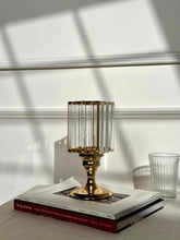 High Objects Crystal Luxe candle stand with faceted glass hurricane top and gold pedestal base, styled on books.