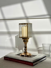 High Objects Crystal Luxe candle stand with gold pedestal base and faceted glass hurricane top holding a cream pillar candle.