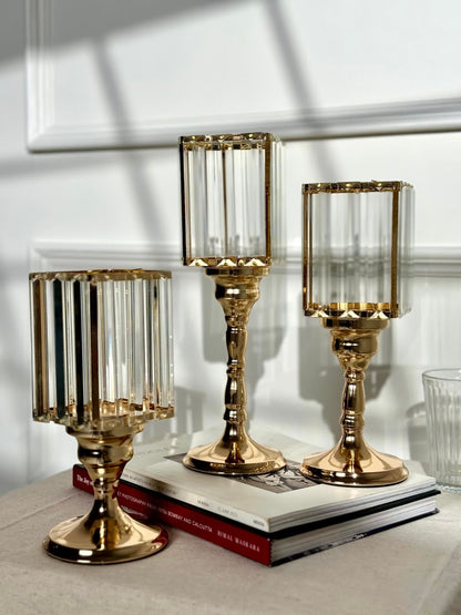 High Objects Crystal Luxe candle stand set with gold pedestal bases and faceted glass hurricane tops. Set of 3.