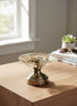 High Objects Crystal Petal Accent Platter, clear glass with embossed pattern on a metallic pedestal base.