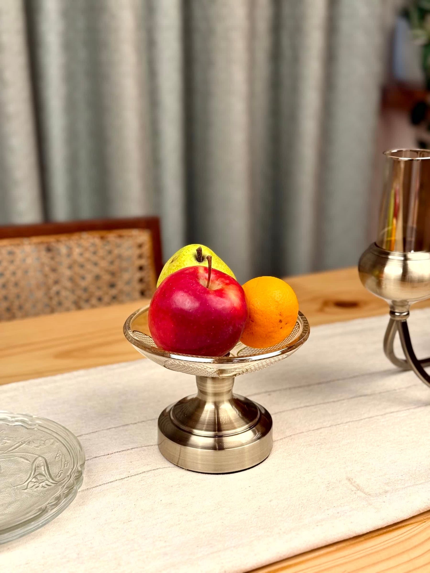 High Objects Crystal Petal Accent Platter with metallic base, holding apples and an orange.