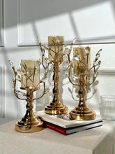 High Objects gold metal candle stands with amber glass hurricanes and crystal leaves, set of 3.