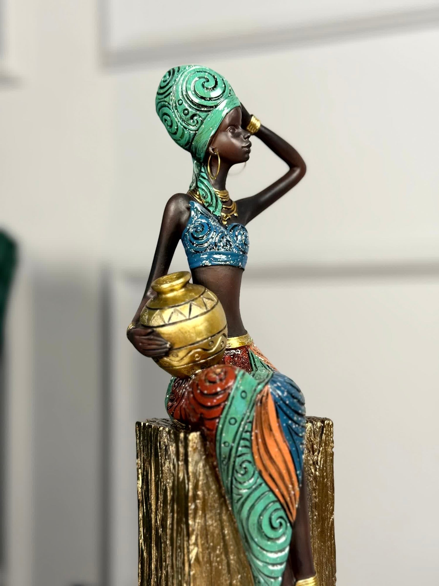 High Objects Desert Queen showpiece, a 16-inch polyresin figurine of an African tribal woman holding a gold pot, with intricate detailing and gold accents.