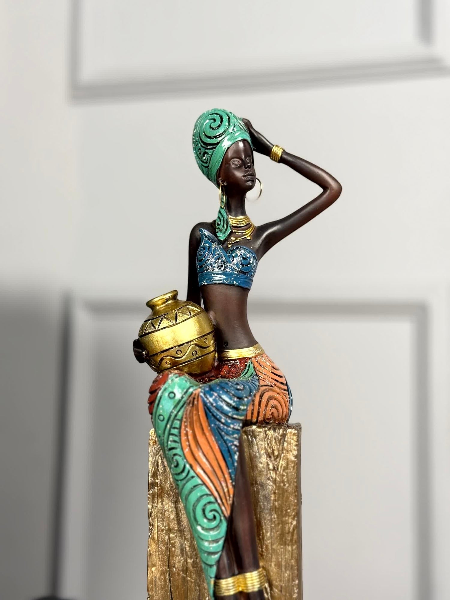 High Objects Desert Queen showpiece, a 16-inch polyresin figurine of an African woman holding a gold pot, with intricate detailing and gold accents.
