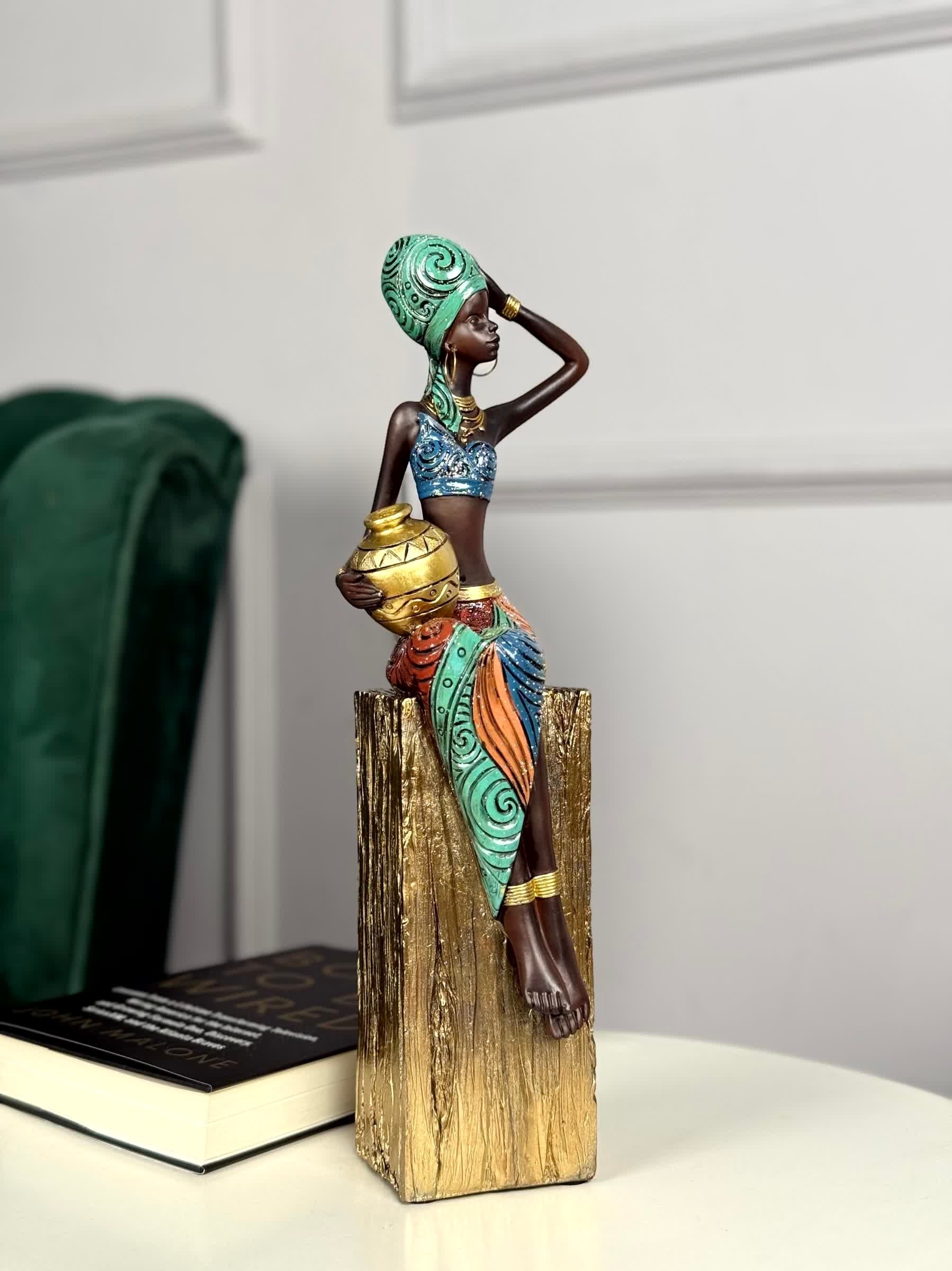 High Objects Desert Queen showpiece, an African tribal woman figurine in polyresin with gold accents, holding a pot.