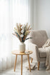 High Objects Maison Éclat dried botanical arrangement with cotton bolls, eucalyptus, grasses, and florals in a fluted ceramic vase.