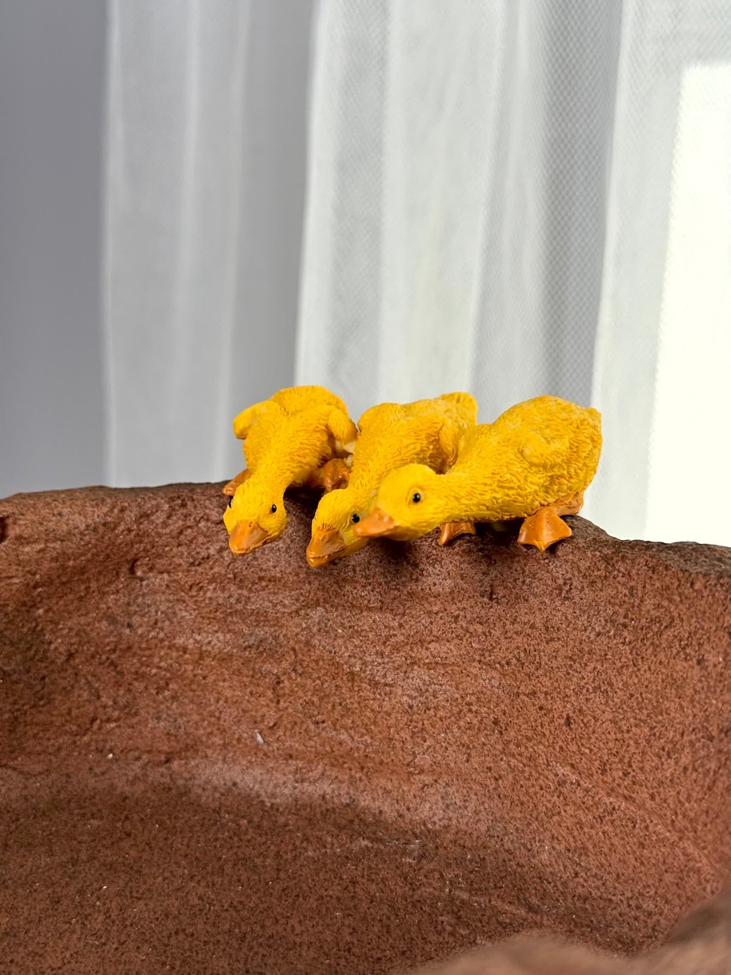 High Objects Duck Bowl Planter Showpiece with three yellow ducklings on a textured stone-style bowl.