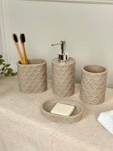 High Objects Dunecraft Bathroom Accessory Set, textured beige resin soap dish, dispenser, and two cups with toothbrushes.