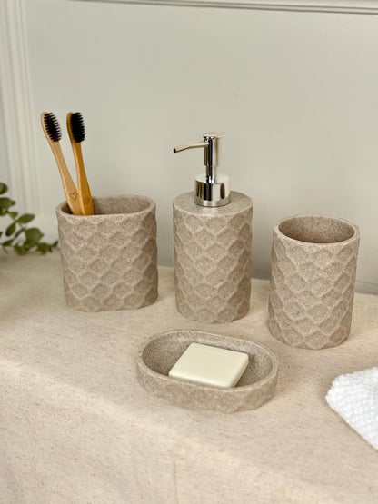 High Objects Dunecraft Bathroom Accessory Set, textured beige resin soap dish, dispenser, and two cups with toothbrushes.
