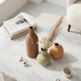 High Objects Earth Tone Vase Set: terracotta, sage green, and ochre ceramic vases with matte finish, one with pampas grass.