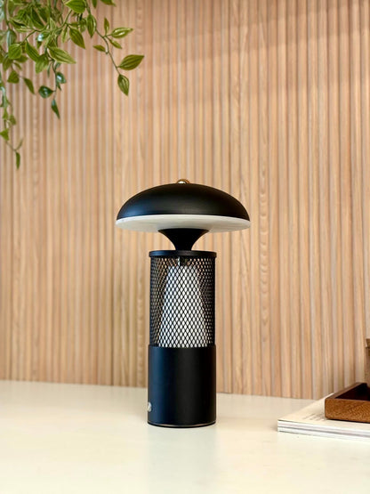High Objects Eclipse Mesh Table Lamp in matte black with gold detailing, mushroom silhouette, textured mesh body, and diffused downward light.
