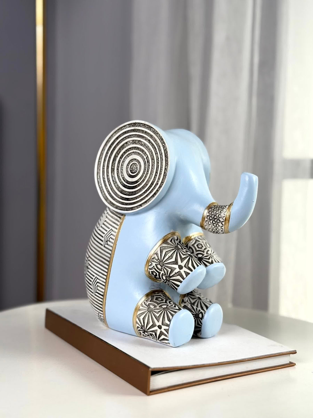 High Objects Elysian Trunk Figurine (Big B) in soft blue polyresin with black and gold geometric patterns and concentric ear details.