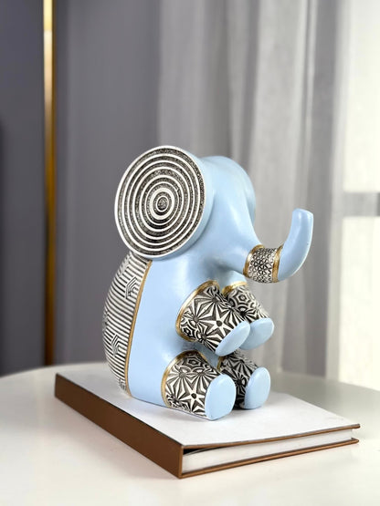 High Objects Elysian Trunk Figurine (Big B) in soft blue polyresin with black and gold geometric patterns and concentric ear details.