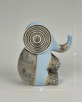 High Objects Elysian Trunk Figurine in soft blue with black and white geometric patterns and gold accents. Features concentric ear detailing.
