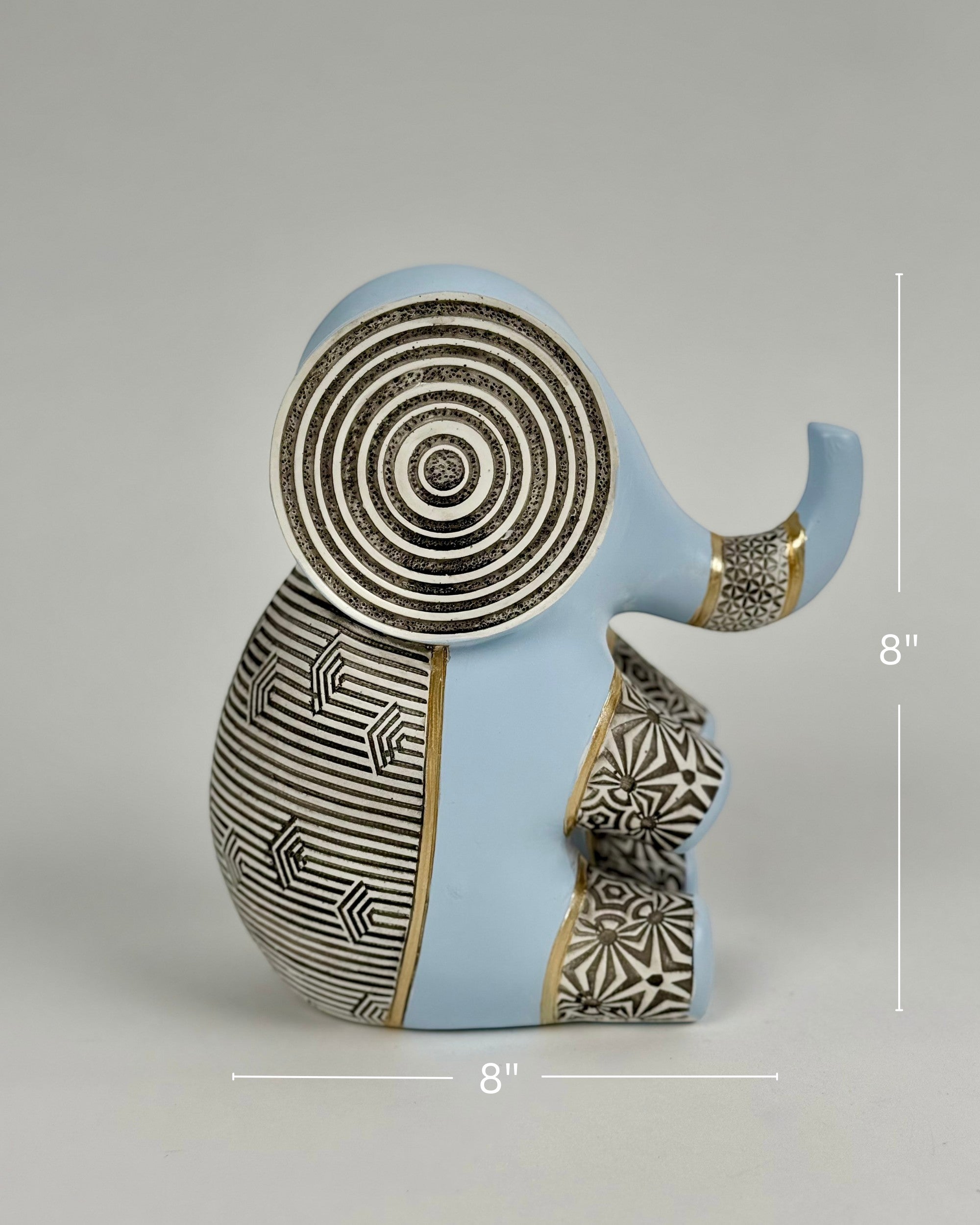 High Objects Elysian Trunk Figurine in soft blue with black and white geometric patterns and gold accents. Features concentric ear detailing.