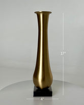 High Objects Eterna Gold Vase, 17" tall, with a sleek, elongated silhouette and a radiant golden finish on a black square base.