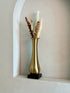 High Objects Eterna Gold Vase with a sleek silhouette and black square base, holding dried eucalyptus and pampas grass.