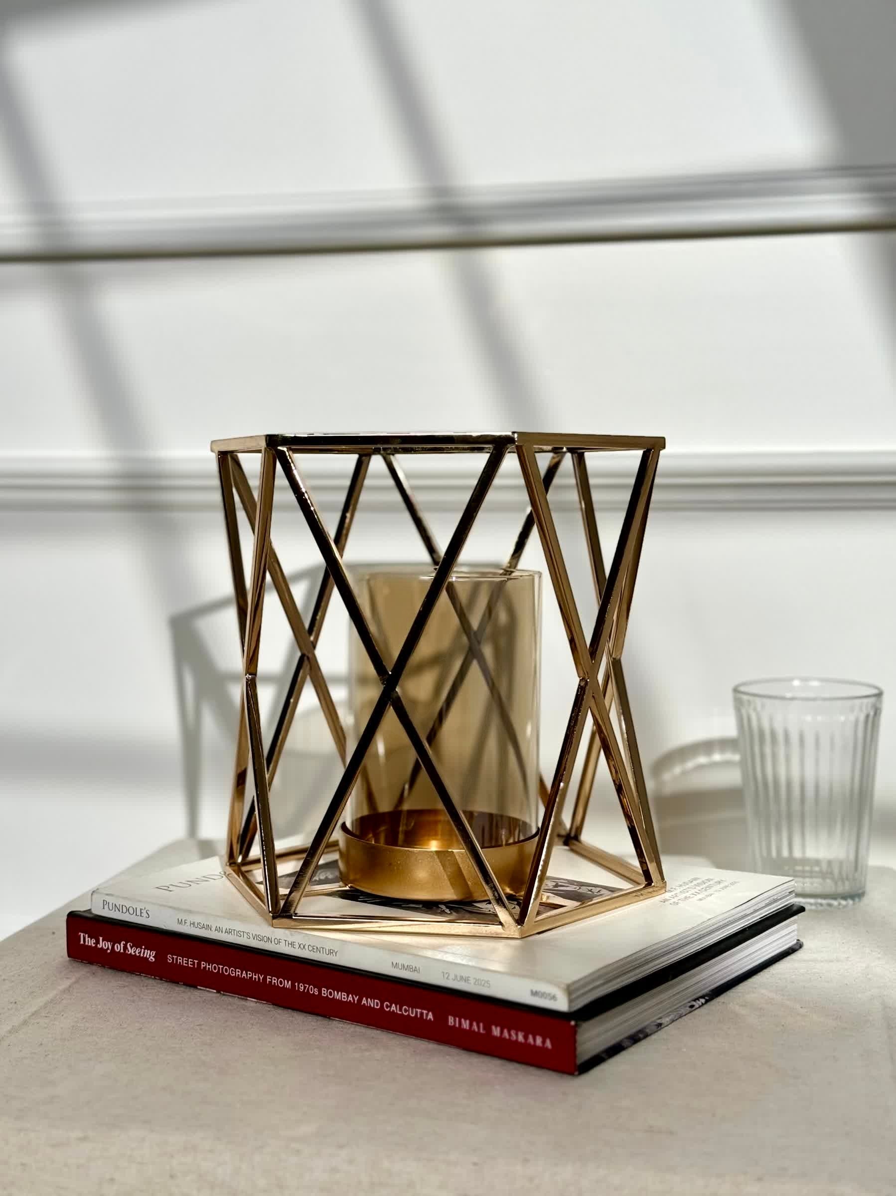 High Objects Gilded Prism Candle Stand, gold metal geometric frame with amber glass holder, modern decorative accent.