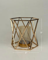 High Objects Gilded Prism Candle Stand with gold-finished geometric frame and amber glass holder.
